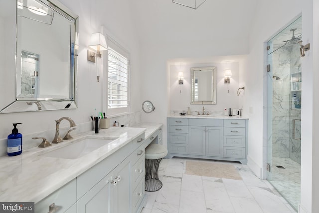155 E Oakland Ave, Doylestown, PA 18901 - bathroom featuring marble look tile flooring, a marble finish shower, and two vanities