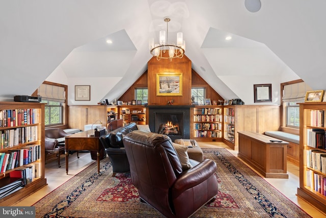 155 E Oakland Ave, Doylestown, PA 18901 - living area featuring vaulted ceiling, plenty of natural light, wooden walls, a warm lit fireplace, and a chandelier