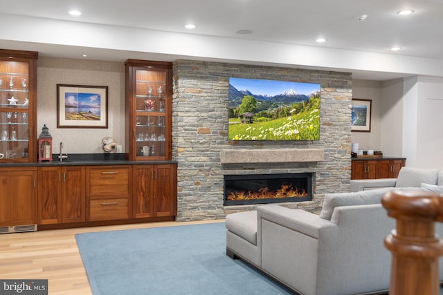 155 E Oakland Ave, Doylestown, PA 18901 - living room featuring light wood-style flooring, bar with sink, a fireplace, and recessed lighting