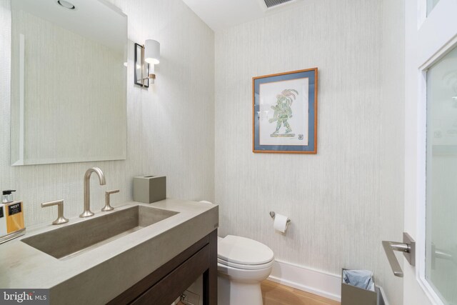 155 E Oakland Ave, Doylestown, PA 18901 - bathroom featuring vanity, toilet, wallpapered walls, and wood finished floors