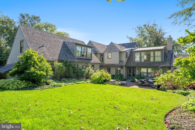 155 E Oakland Ave, Doylestown, PA 18901 - view of front of home featuring a chimney, a front lawn, and a patio area