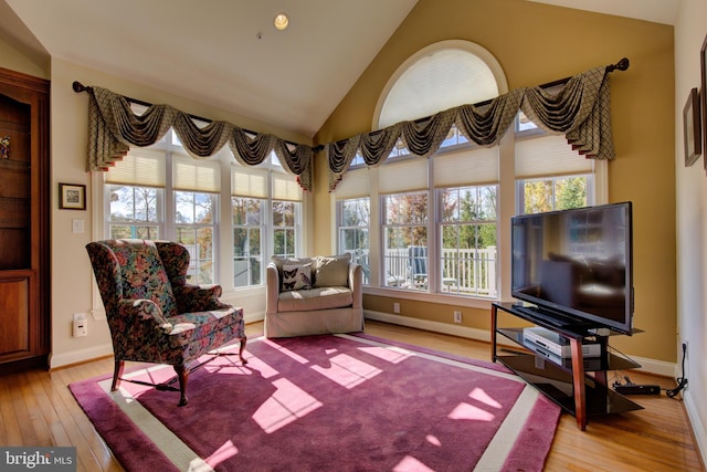 sunroom featuring vaulted ceiling and plenty of natural light