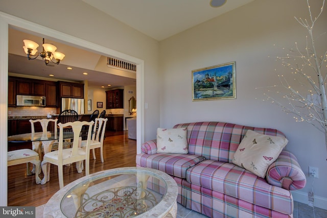 living room featuring hardwood / wood-style floors and an inviting chandelier