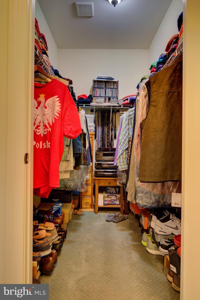 walk in closet with carpet