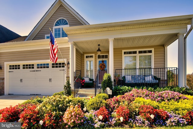 view of front of house featuring a garage and a porch