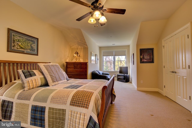 bedroom featuring vaulted ceiling, light colored carpet, and ceiling fan