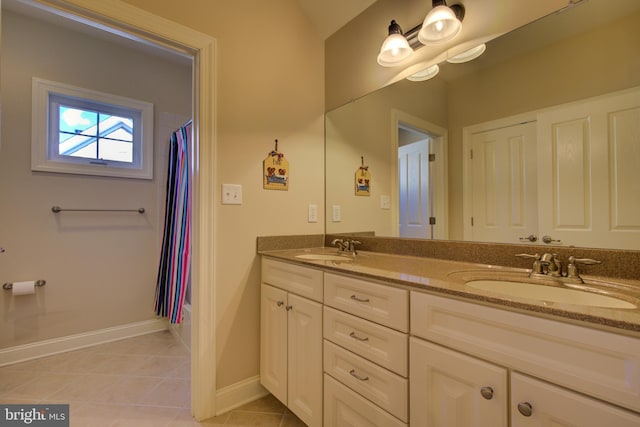 bathroom with vanity, tile patterned floors, and shower / bath combo with shower curtain