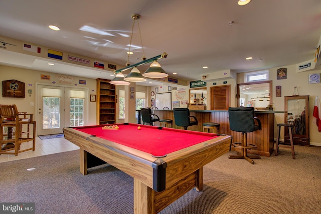 playroom featuring bar area, pool table, and light carpet