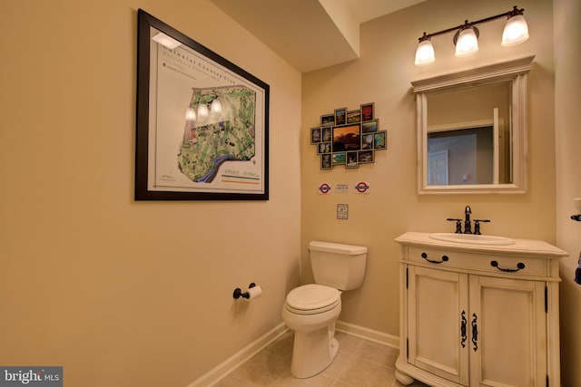 bathroom with tile patterned flooring, vanity, and toilet