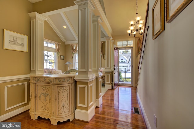 interior space featuring hardwood / wood-style floors, plenty of natural light, and ornate columns