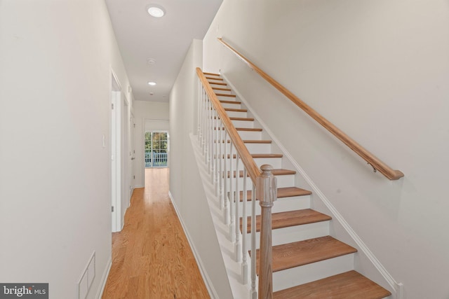 stairway with recessed lighting, visible vents, and wood finished floors