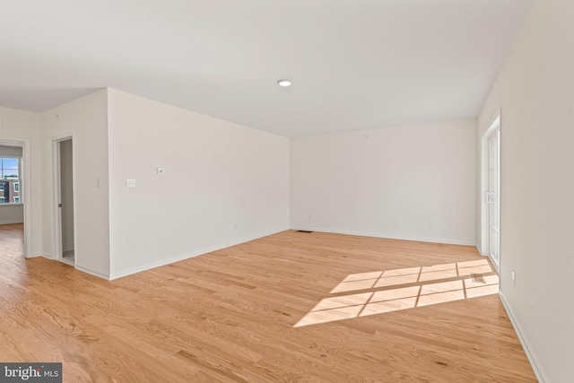unfurnished room featuring light wood-type flooring and baseboards