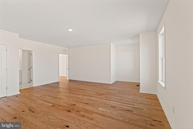 spare room featuring light hardwood / wood-style floors