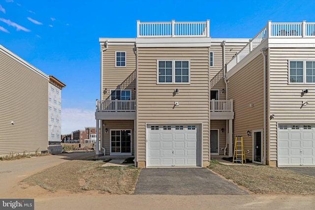 townhome / multi-family property featuring a balcony and a garage