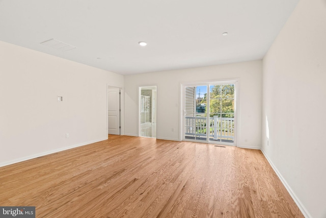 spare room featuring light wood-type flooring, visible vents, baseboards, and recessed lighting