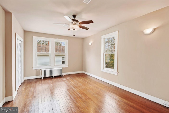 205 Walnut St, Pocomoke City, MD 21851 - unfurnished room with radiator heating unit, plenty of natural light, hardwood / wood-style flooring, and baseboards