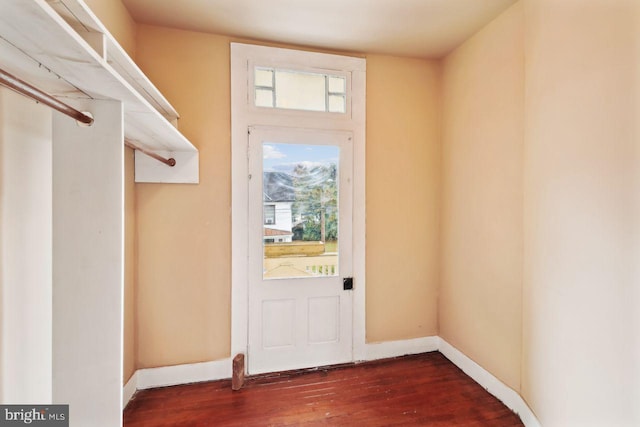 doorway with dark wood-type flooring