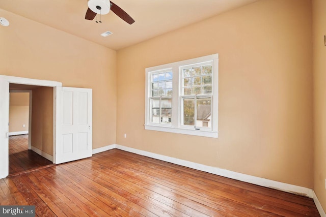 unfurnished room with ceiling fan and wood-type flooring