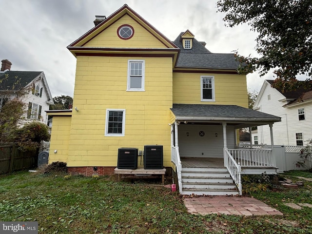 back of property featuring central air condition unit and a porch