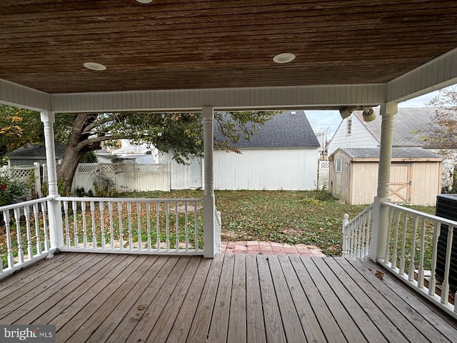 wooden deck featuring a shed