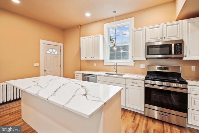 205 Walnut St, Pocomoke City, MD 21851 - kitchen with appliances with stainless steel finishes, a sink, a center island, light wood-style flooring, and recessed lighting