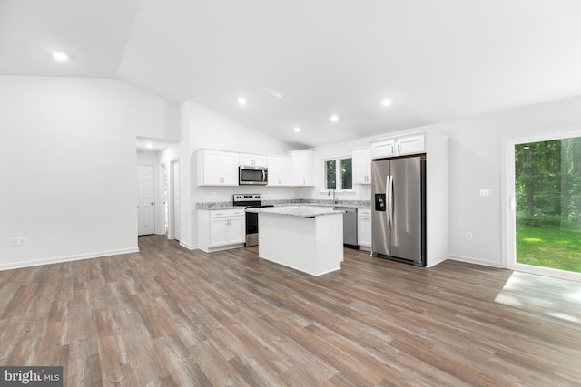 kitchen with a center island, appliances with stainless steel finishes, white cabinetry, and light wood-type flooring