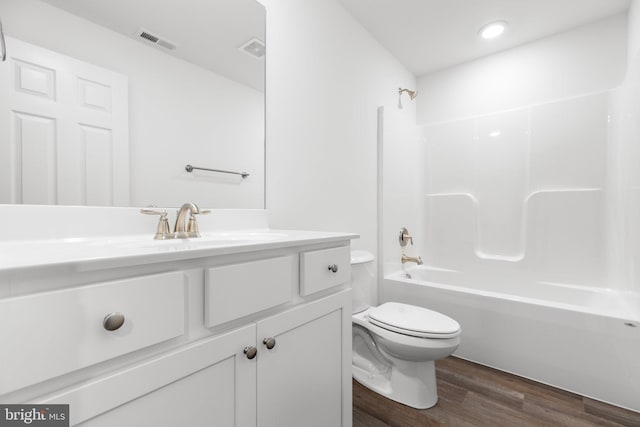 full bathroom featuring vanity, toilet, shower / bathtub combination, and hardwood / wood-style floors