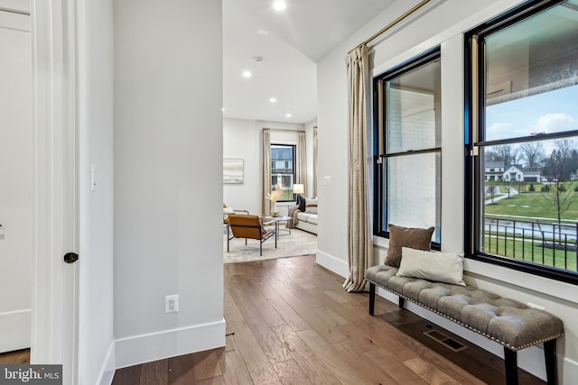 corridor with hardwood / wood-style flooring