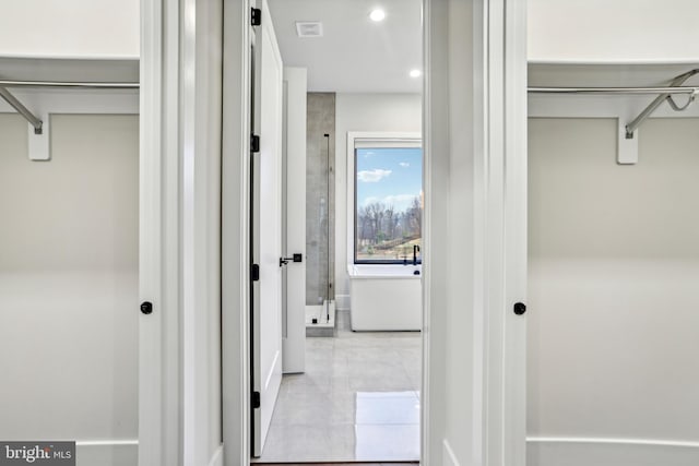 corridor with light tile patterned floors