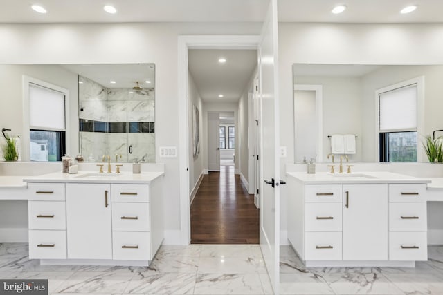 bathroom with hardwood / wood-style floors, vanity, and walk in shower