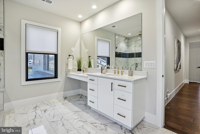 bathroom featuring wood-type flooring, vanity, and a shower with shower door