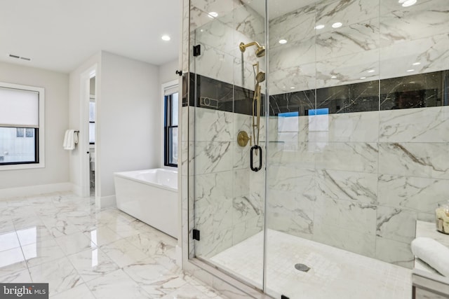 bathroom featuring shower with separate bathtub