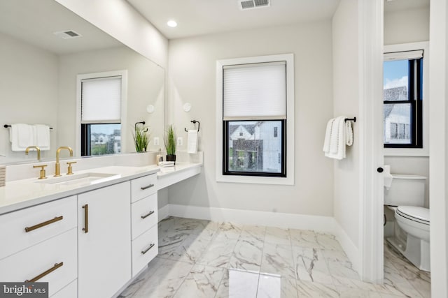 bathroom featuring vanity and toilet