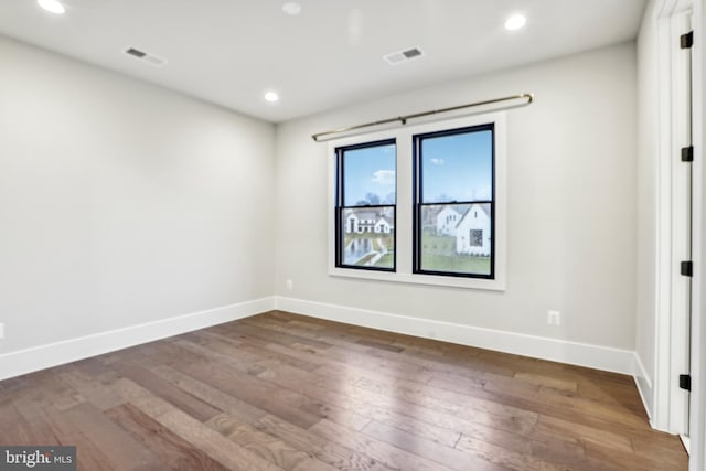 unfurnished room featuring hardwood / wood-style floors