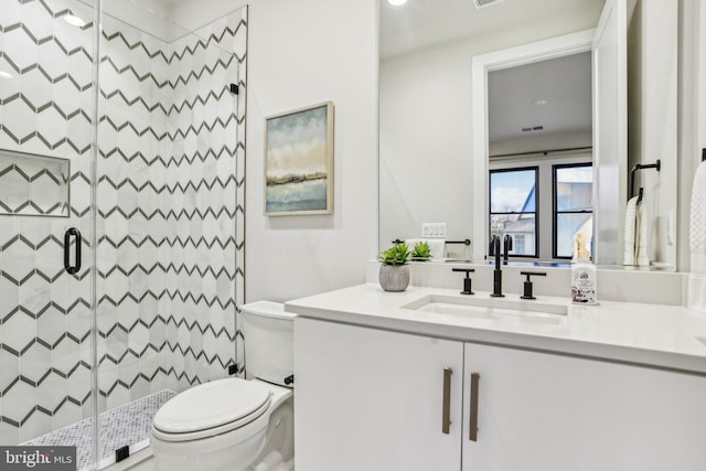 bathroom featuring vanity, toilet, and walk in shower