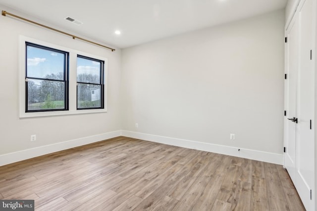 empty room with light hardwood / wood-style flooring