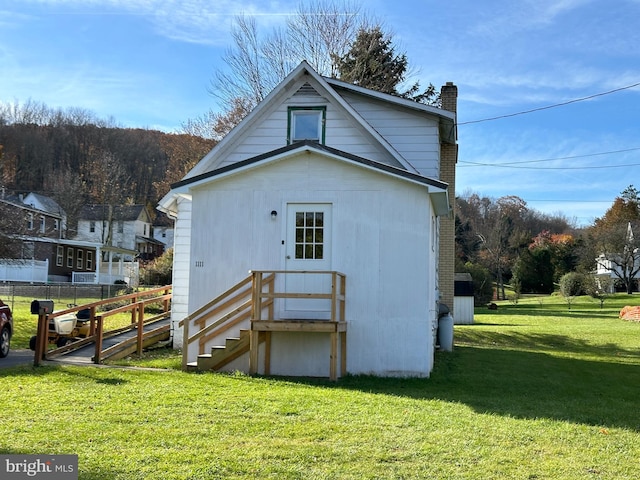 rear view of house with a yard