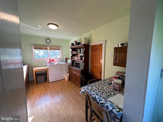 bedroom featuring washer and clothes dryer and light wood-type flooring