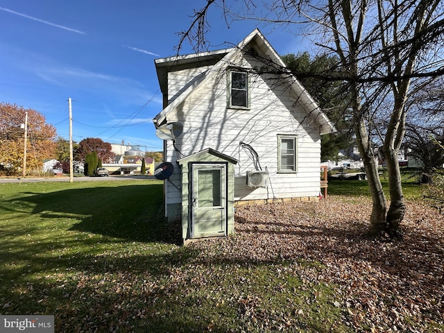 rear view of house featuring a lawn