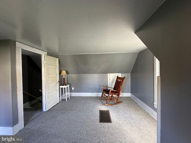 bonus room featuring lofted ceiling and carpet