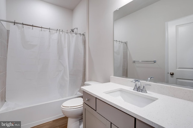 full bathroom with shower / bath combo, vanity, hardwood / wood-style flooring, and toilet