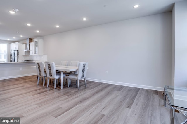 dining space with light wood-type flooring