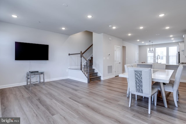 unfurnished dining area with light wood-type flooring