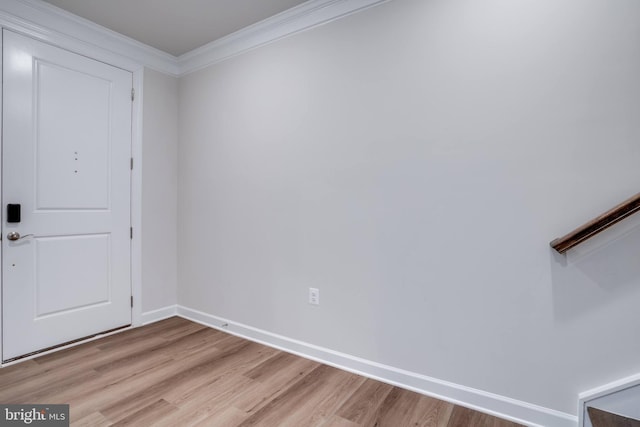 entryway with crown molding and light hardwood / wood-style flooring