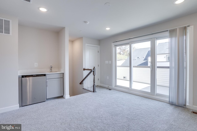 interior space featuring light carpet and stainless steel refrigerator