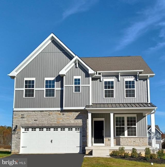 view of front facade featuring a porch and a garage