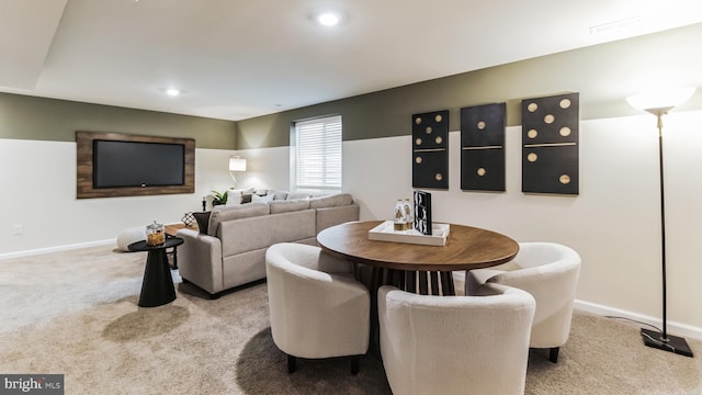 dining area featuring light carpet