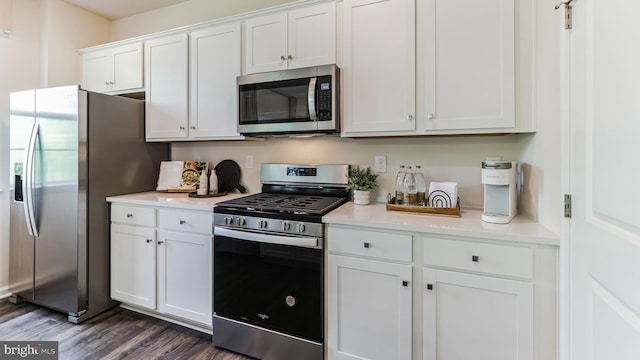 kitchen featuring white cabinetry, dark wood-type flooring, and appliances with stainless steel finishes