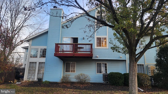 rear view of property featuring a balcony