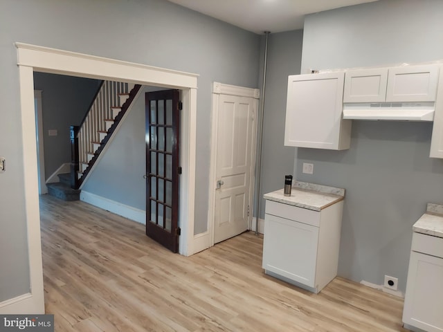 kitchen featuring white cabinets and light wood-type flooring